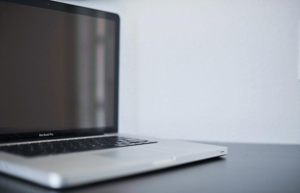A sleek silver laptop on a modern desk against a white backdrop, perfect for work settings.